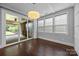 Bright sunroom features large windows with sliding glass doors that leads to an outdoor patio at 1012 N Sharon Amity Rd, Charlotte, NC 28211