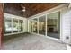 Open sunroom with natural stone flooring, fireplace and large windows at 1012 N Sharon Amity Rd, Charlotte, NC 28211
