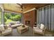 Inviting sunroom with natural light, brick fireplace, and stylish furniture perfect for relaxation and entertaining at 1012 N Sharon Amity Rd, Charlotte, NC 28211
