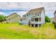 Spacious backyard with a lovely screened porch and lush green lawn, ideal for Gathering activities at 1044 Shiloh Bend Trl, Fort Mill, SC 29715