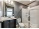 Bathroom including a vanity with a dark wood cabinet and walk-in shower with glass door at 1044 Shiloh Bend Trl, Fort Mill, SC 29715