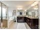 Bright bathroom featuring double vanity, walk in shower, and soaking tub at 1044 Shiloh Bend Trl, Fort Mill, SC 29715