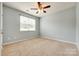 Neutral bedroom with carpet, a ceiling fan, and a large window offering natural light at 1044 Shiloh Bend Trl, Fort Mill, SC 29715