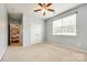 Neutral bedroom featuring carpet, ceiling fan, and window, with a view into the living space at 1044 Shiloh Bend Trl, Fort Mill, SC 29715