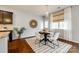 Cozy dining area with natural light, a round table, white chairs, and hardwood floors at 1044 Shiloh Bend Trl, Fort Mill, SC 29715
