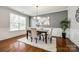 Dining room featuring hardwood floors, white wainscoting, and modern chandelier at 1044 Shiloh Bend Trl, Fort Mill, SC 29715