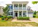 Charming two-story home featuring a covered porch, black shutters, and beautiful landscaping at 1044 Shiloh Bend Trl, Fort Mill, SC 29715