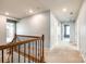 Upstairs hallway featuring carpet, railing, and multiple doors leading to various rooms at 1044 Shiloh Bend Trl, Fort Mill, SC 29715