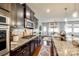 Bright kitchen boasts granite countertops, stainless appliances, dark wood cabinets, and an adjacent dining area at 1044 Shiloh Bend Trl, Fort Mill, SC 29715