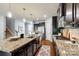Spacious kitchen features an island, granite countertops, stainless steel appliances, and dark wood cabinets at 1044 Shiloh Bend Trl, Fort Mill, SC 29715