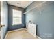 Laundry room with tiled floor, utility connections, and white wire rack at 1044 Shiloh Bend Trl, Fort Mill, SC 29715