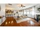 Open-concept living space with hardwood floors, fireplace, kitchen view, and plenty of natural light at 1044 Shiloh Bend Trl, Fort Mill, SC 29715