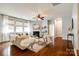 Sunlit living room featuring a fireplace, ceiling fan, hardwood floors, and neutral decor at 1044 Shiloh Bend Trl, Fort Mill, SC 29715