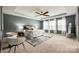Spacious main bedroom with sitting area, tray ceiling, ceiling fan, and carpeted floor at 1044 Shiloh Bend Trl, Fort Mill, SC 29715