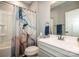 Clean bathroom featuring a single vanity, framed mirror, a bathtub with shower, and gray walls at 105 Chase View Ln, Troutman, NC 28166