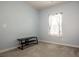 Empty bedroom featuring neutral carpet, pale blue walls, one window, and a black TV stand at 105 Chase View Ln, Troutman, NC 28166