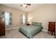 Cozy bedroom with a ceiling fan and two windows dressed with floral drapes at 105 Chase View Ln, Troutman, NC 28166
