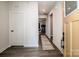 Inviting entryway with wood-look floors, leads to the spacious living area with lots of natural light at 105 Chase View Ln, Troutman, NC 28166