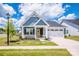 Charming single-Gathering home boasts a manicured lawn, attached two-car garage, and inviting front porch at 105 Chase View Ln, Troutman, NC 28166