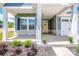 Inviting front porch with stone accents, offers a cozy entrance to the home, and manicured garden beds at 105 Chase View Ln, Troutman, NC 28166