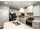 Well-equipped kitchen features gray cabinets, stainless steel appliances, and a spacious island with seating at 105 Chase View Ln, Troutman, NC 28166