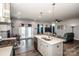 Open kitchen and living room concept features a large island, stainless appliances, and wood-look flooring at 105 Chase View Ln, Troutman, NC 28166