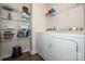 Functional laundry room featuring modern white washer and dryer, plus ample shelving for storage at 105 Chase View Ln, Troutman, NC 28166