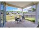 Covered patio with chairs, table, and wrought iron fence in a walkable neighborhood at 105 Chase View Ln, Troutman, NC 28166