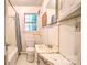 Simple bathroom with a bathtub, toilet, vanity, and natural light at 109 N Belvedere Ave, Gastonia, NC 28054