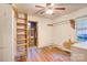 Bedroom featuring hardwood floors, a ladder leading to an elevated area, and natural light at 109 N Belvedere Ave, Gastonia, NC 28054