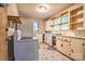 Functional kitchen area with vintage appliances, linoleum floors, and natural light at 109 N Belvedere Ave, Gastonia, NC 28054