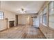 Cozy living room featuring a fireplace, hardwood floors, and a doorway leading to a room with natural light at 109 N Belvedere Ave, Gastonia, NC 28054