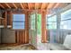 Unfinished room featuring exposed studs and an open doorway to the exterior at 109 N Belvedere Ave, Gastonia, NC 28054
