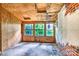 Room with plywood walls, brick, and bright natural light through multiple windows at 109 N Belvedere Ave, Gastonia, NC 28054