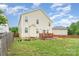 Spacious backyard featuring a wood deck, lush lawn, and privacy fence at 1105 Bottle Brush Ln, Harrisburg, NC 28075
