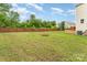 Large, private backyard with a brick fire pit and wooden privacy fence surrounding the property at 1105 Bottle Brush Ln, Harrisburg, NC 28075