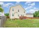 Spacious backyard featuring a wood deck, lush lawn, and privacy fence at 1105 Bottle Brush Ln, Harrisburg, NC 28075
