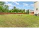 Large, private backyard with a brick fire pit and wooden privacy fence surrounding the property at 1105 Bottle Brush Ln, Harrisburg, NC 28075