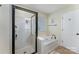 Bathroom featuring walk-in shower and a soaking tub perfect for relaxation at 1105 Bottle Brush Ln, Harrisburg, NC 28075
