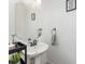 Cozy half bathroom featuring a pedestal sink and a decorative mirror at 1105 Bottle Brush Ln, Harrisburg, NC 28075