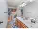 Bathroom featuring double sinks, decorative mirrors, and stylish decor at 1105 Bottle Brush Ln, Harrisburg, NC 28075