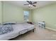 Bright bedroom featuring a ceiling fan, window, and desk for studying or hobbies at 1105 Bottle Brush Ln, Harrisburg, NC 28075
