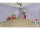 Bedroom with purple walls, natural light and space for activities at 1105 Bottle Brush Ln, Harrisburg, NC 28075