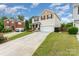 Lovely two-story home with inviting curb appeal, long driveway, and well-kept landscaping at 1105 Bottle Brush Ln, Harrisburg, NC 28075