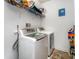 Functional laundry room with modern washer and dryer units and overhead storage shelves at 1105 Bottle Brush Ln, Harrisburg, NC 28075
