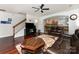 Cozy living room featuring hardwood floors, a ceiling fan, and an open view to the kitchen at 1105 Bottle Brush Ln, Harrisburg, NC 28075