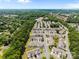 Extensive aerial view showcasing the community nestled among a dense canopy of trees at 12407 Crowley Ct, Charlotte, NC 28277