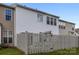 Rear exterior view of a multi-story home with a fenced backyard and green space at 12407 Crowley Ct, Charlotte, NC 28277