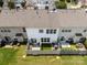 Aerial shot of townhome backyards with green grass, fenced-in patios, and outdoor seating at 12407 Crowley Ct, Charlotte, NC 28277