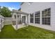 Backyard featuring a decorative arbor, low-maintenance turf and a patio area with furniture at 12407 Crowley Ct, Charlotte, NC 28277